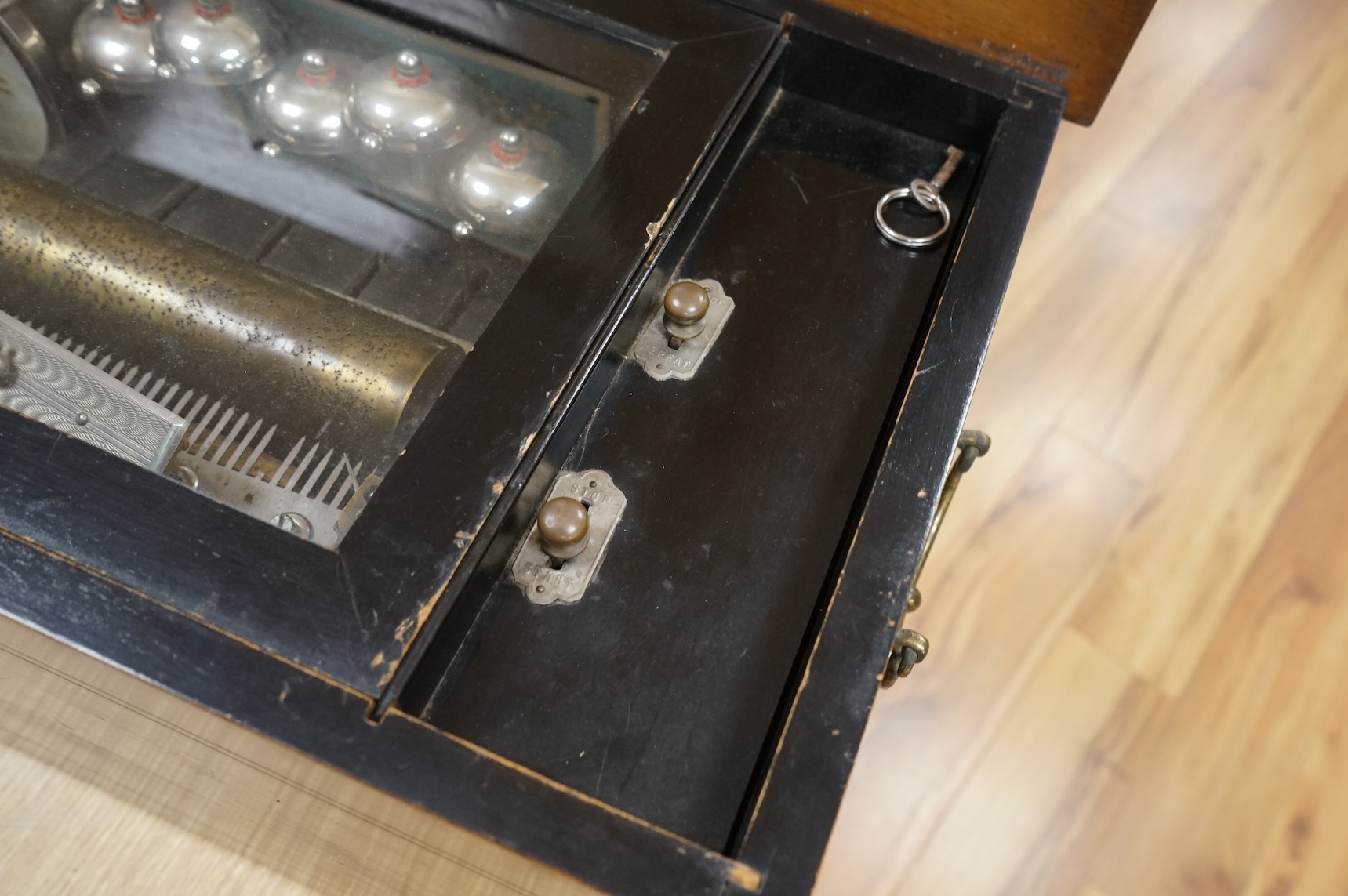 A late 19th century Swiss music box in a rosewood and ebonised case, playing twelve airs on a 52 tooth comb, five bells and a drum, 60cm wide, 27cm high, 32.5cm deep.